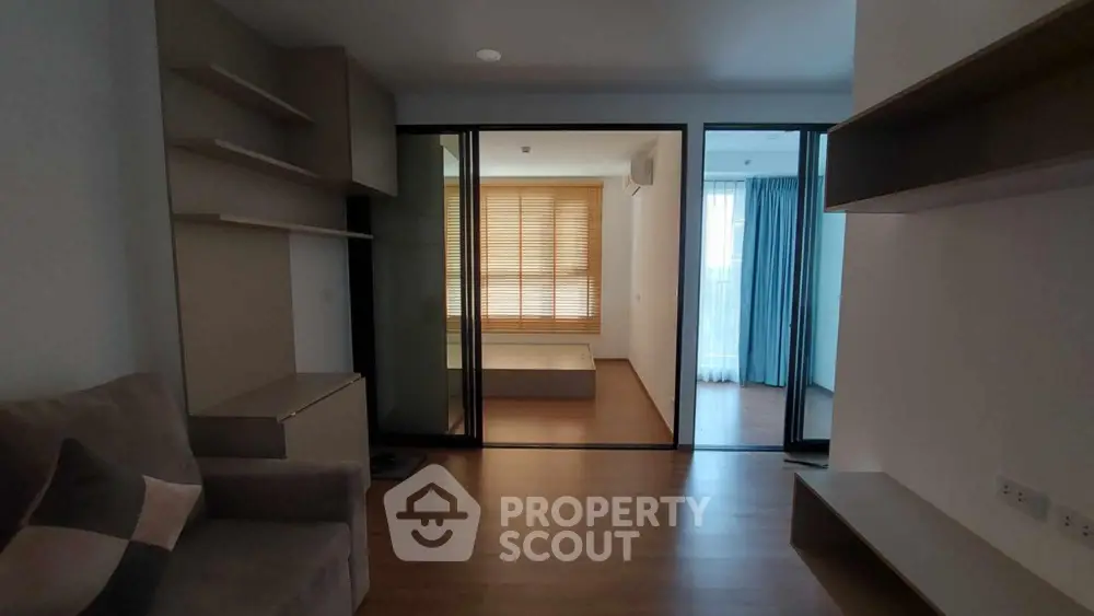 Modern apartment interior with sliding glass doors and wooden flooring