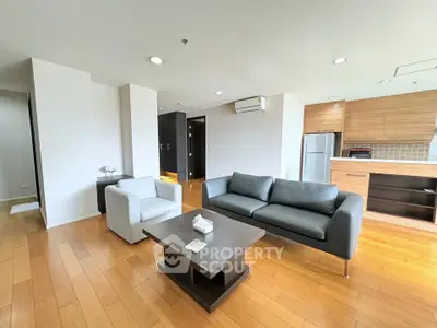 Spacious modern living room with wooden flooring and stylish furniture