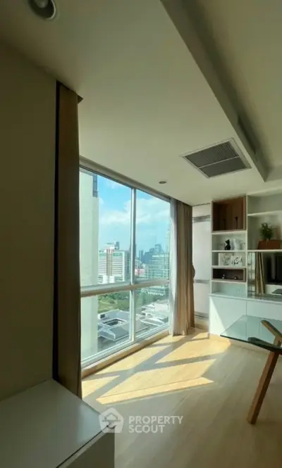 Modern living room with large windows offering stunning city views