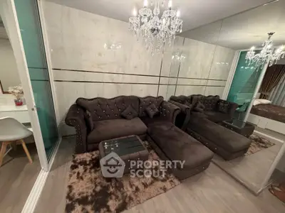 Luxurious living room with plush sofa and elegant chandelier