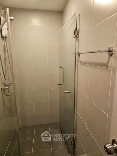 Modern bathroom with glass shower door and sleek tile design
