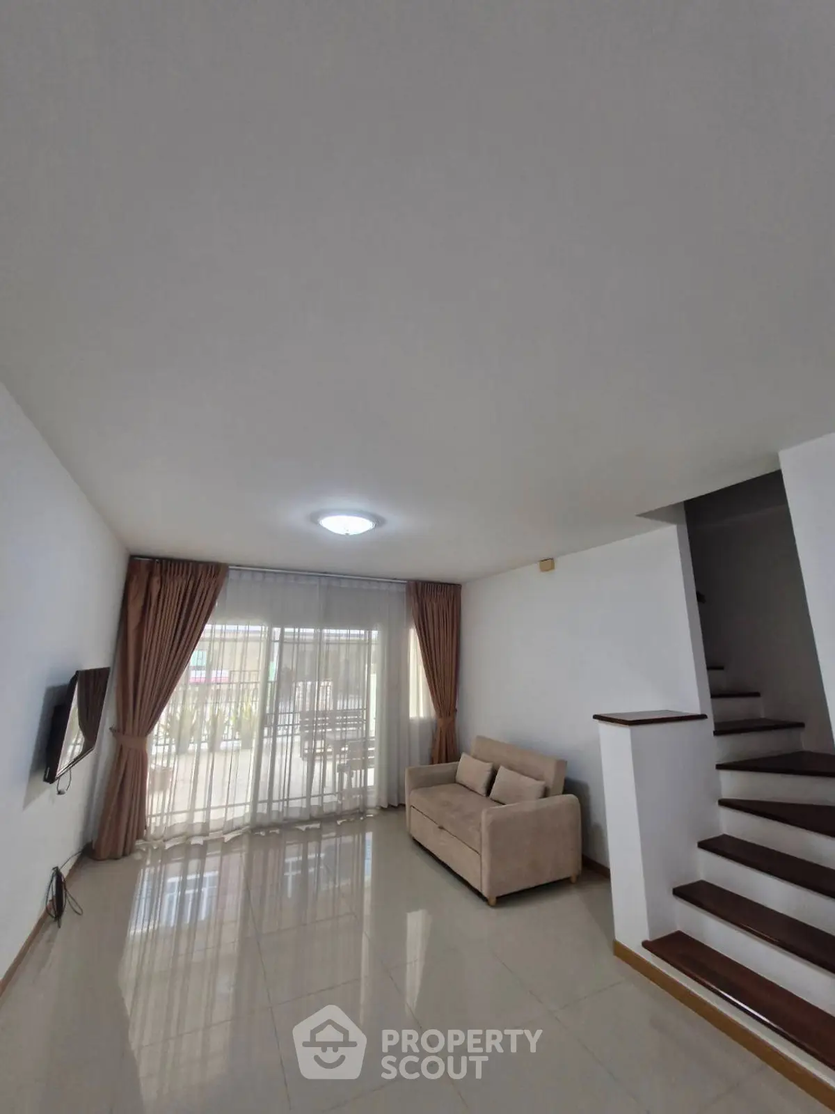 Spacious living room with modern decor and natural light