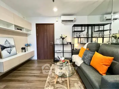 Modern living room with stylish decor, cozy sofa, and elegant shelving in a chic apartment.