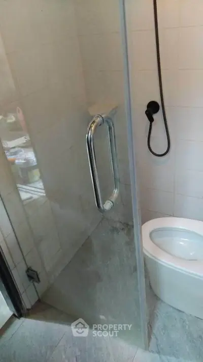 Modern bathroom with glass shower door and sleek fixtures