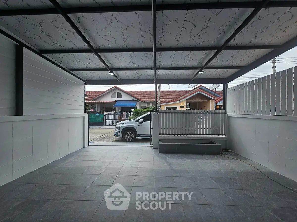Spacious covered parking area with modern design and street view