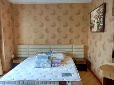 Cozy bedroom with stylish wallpaper and comfortable bed in modern apartment.