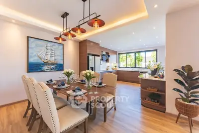 Luxurious open-plan dining and kitchen area with elegant decor and modern lighting.