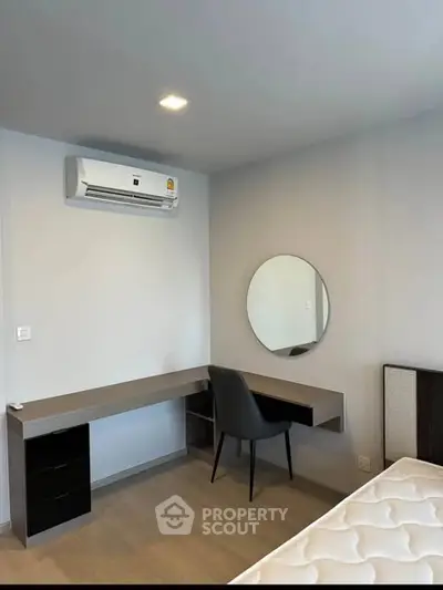 Modern bedroom with sleek desk and air conditioning unit