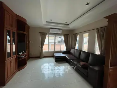 Spacious living room with modern furniture and large windows for natural light