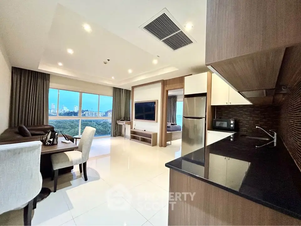 Modern open-layout living room with kitchen and city view