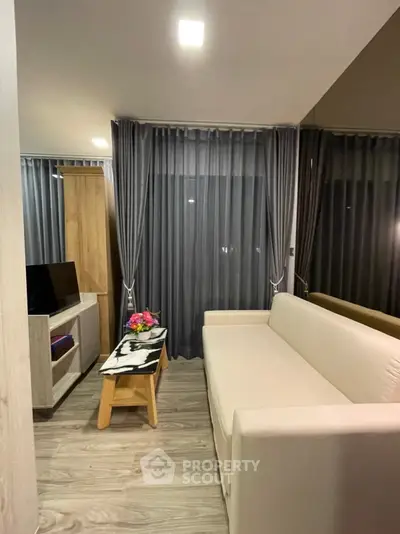 Modern living room with elegant decor and cozy ambiance, featuring a plush sofa and stylish curtains.