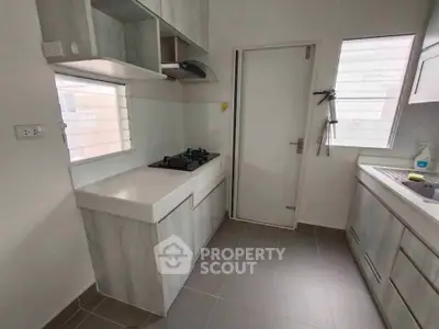 Modern kitchen with sleek cabinetry and gas stove in a bright, minimalist design.