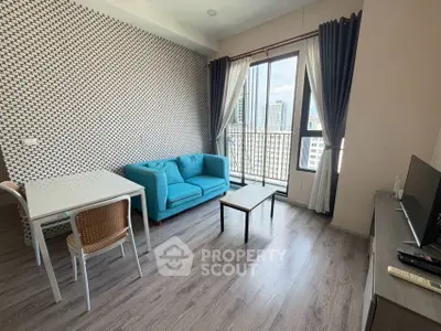 Modern living room with city view, stylish decor, and natural light in urban apartment.