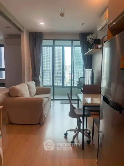 Modern apartment interior with city view, featuring cozy living area and compact kitchen.