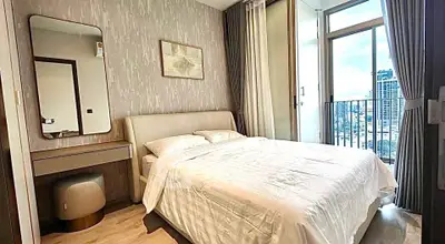 Modern bedroom with city view and elegant decor in high-rise apartment