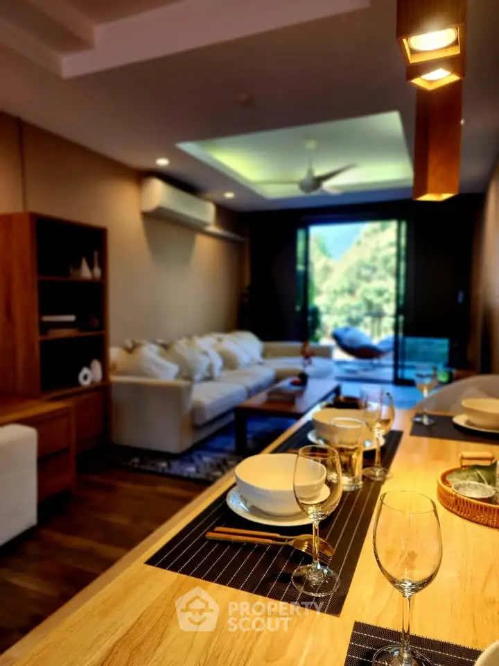 Luxurious living room with elegant dining setup and scenic balcony view