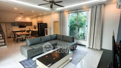 Spacious modern living room with open kitchen and stylish decor