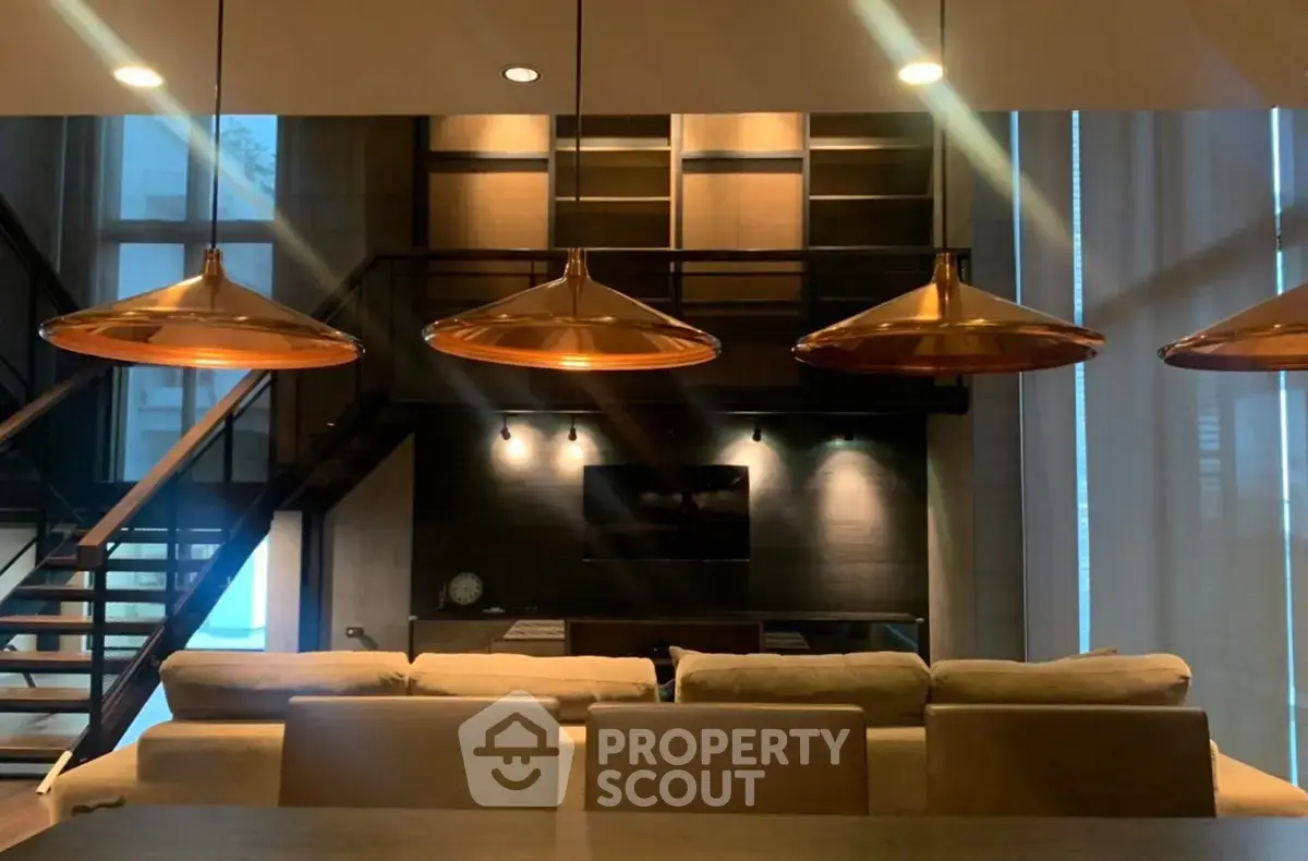 Luxurious modern living room with stylish lighting and elegant staircase