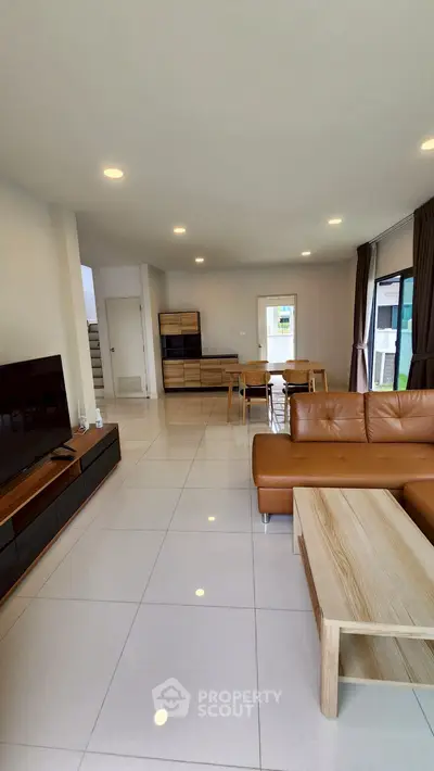 Spacious modern living room with leather sofa and sleek furniture