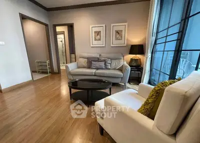 Stylish living room with modern furniture and wooden flooring, perfect for cozy gatherings.