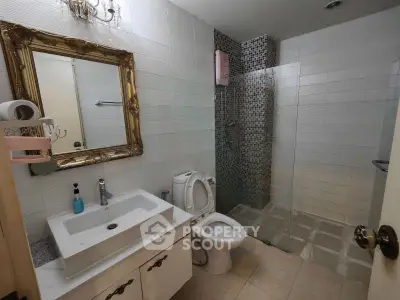 Modern bathroom with elegant mirror and glass shower enclosure