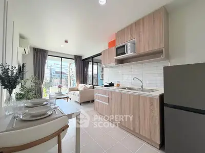 Modern open-layout kitchen and living room with natural light and stylish decor