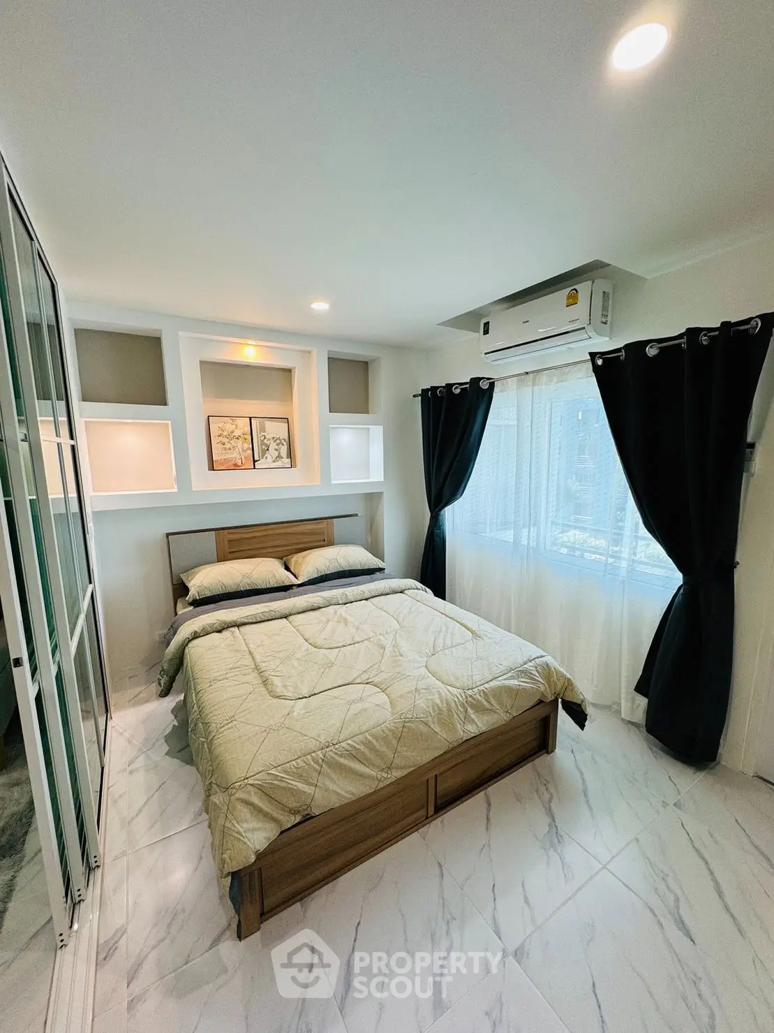 Modern bedroom with elegant decor and natural light, featuring a cozy bed and stylish curtains.