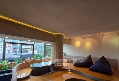 Luxurious modern living room with unique architectural design and city view, featuring cozy seating and ambient lighting.