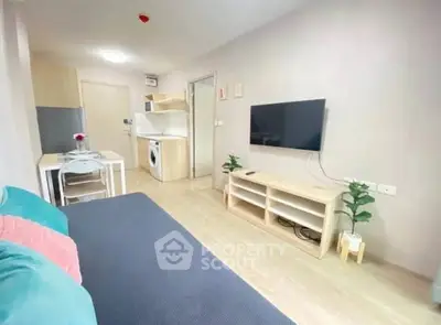 Modern living room with sleek furniture and wall-mounted TV in cozy apartment.