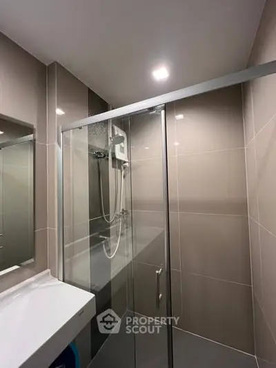 Modern bathroom with sleek shower enclosure and contemporary fixtures.