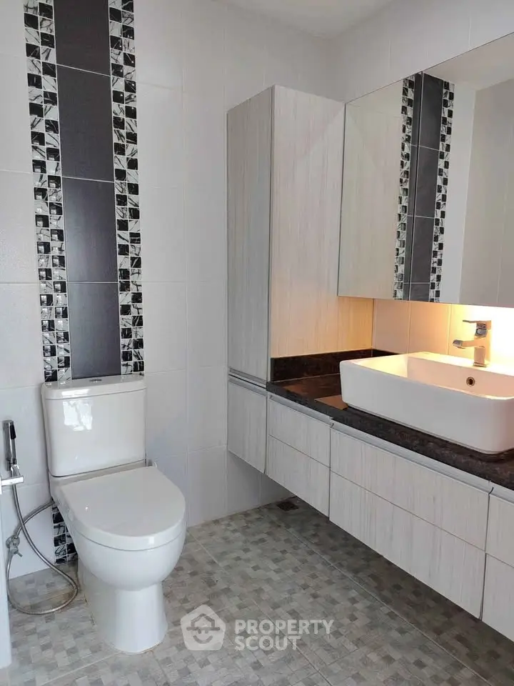 Modern bathroom with stylish tile accents and sleek fixtures