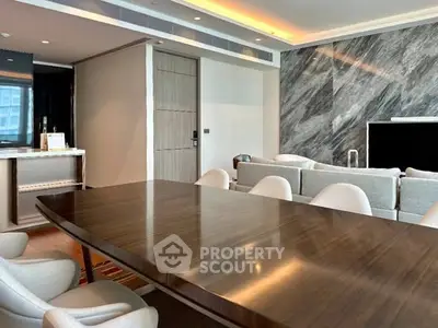 Luxurious modern living room with elegant dining area and sleek marble accent wall.