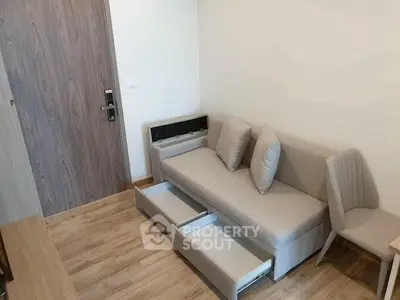 Modern living room with sleek sofa and hidden storage in stylish apartment.