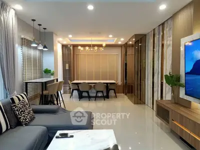 Luxurious modern living room with elegant decor and open dining area, perfect for entertaining guests.