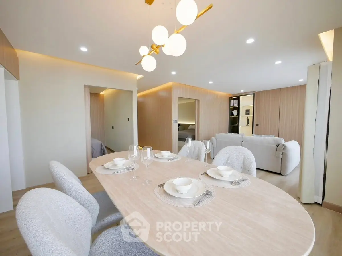 Modern open-plan living room with elegant dining area and stylish lighting