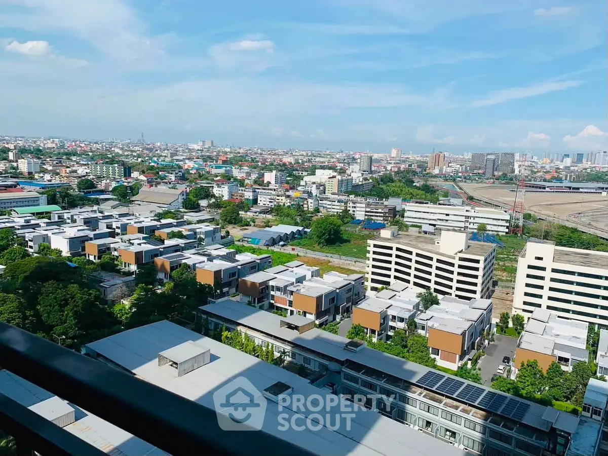 Stunning aerial view of modern urban landscape with residential buildings and clear blue sky.