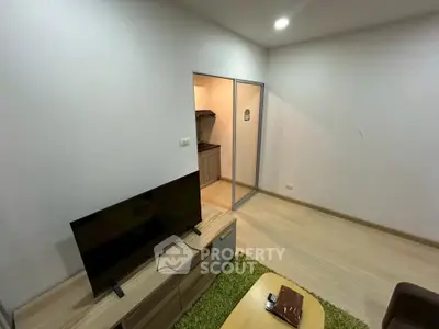 Modern living room with TV and open kitchen layout in cozy apartment