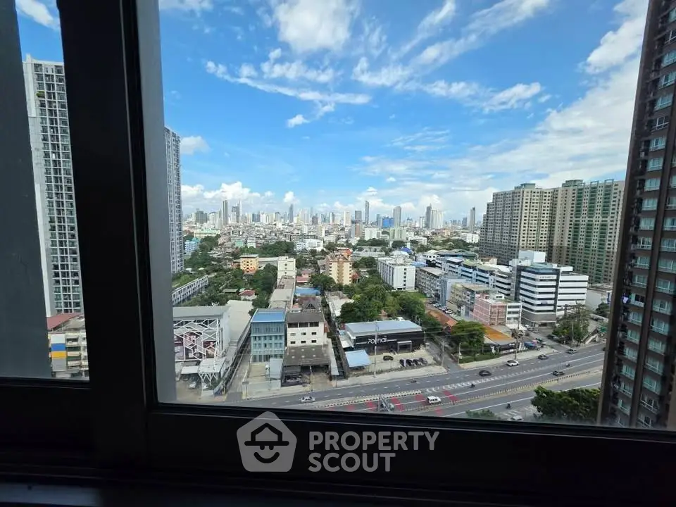 Stunning cityscape view from high-rise apartment window, showcasing urban skyline and vibrant city life.
