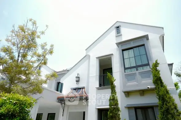 Elegant modern house exterior with lush greenery and stylish architectural design.