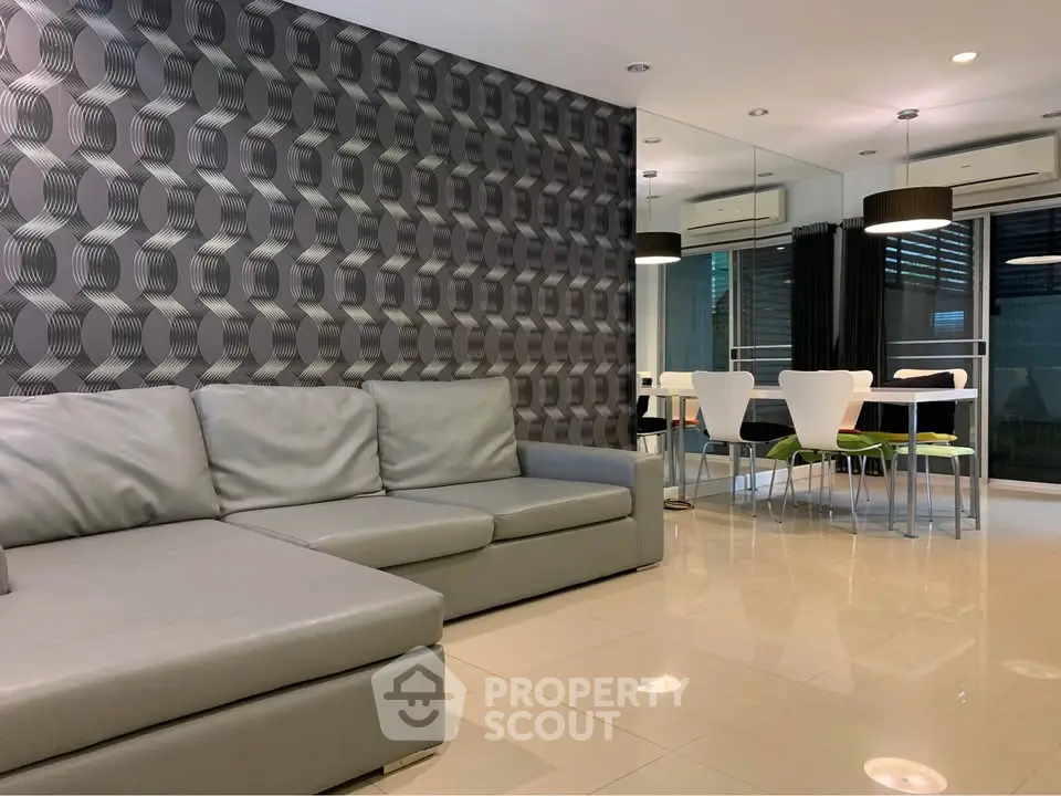 Modern living room with stylish 3D wall design and sleek dining area