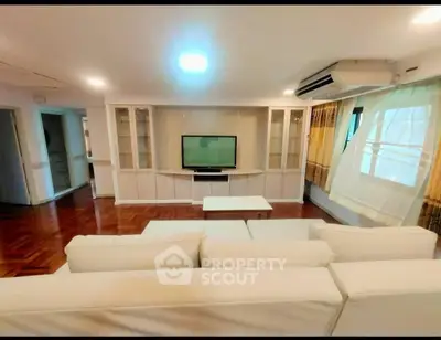 Spacious living room with modern decor and large windows for natural light.