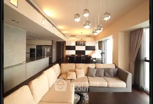 Spacious modern living room with elegant lighting and large sectional sofa