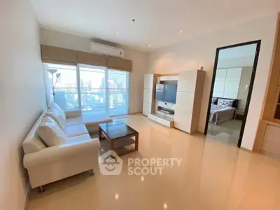 Spacious modern living room with white sofa and city view balcony in luxury apartment.