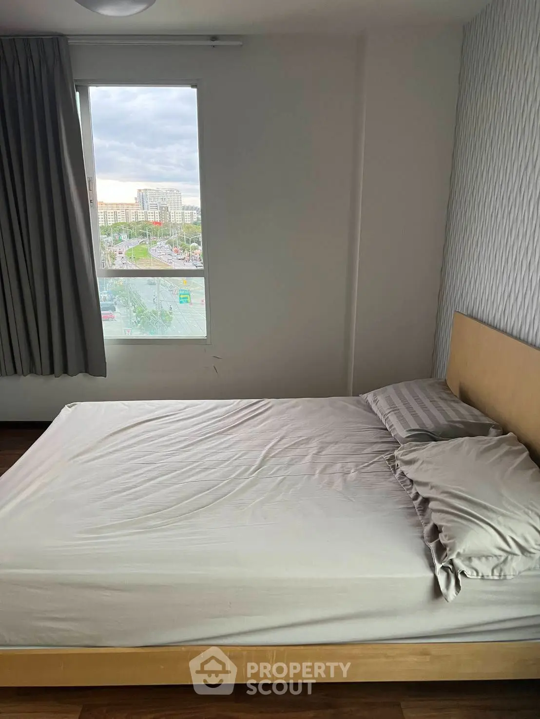 Cozy bedroom with natural light and modern decor, perfect for relaxation and comfort.