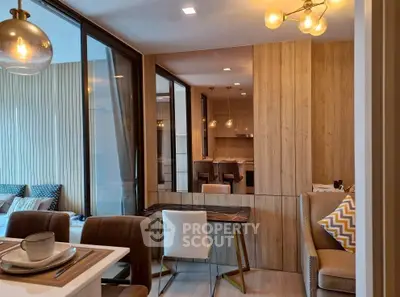 Modern open-plan living and dining area with stylish decor and natural light.