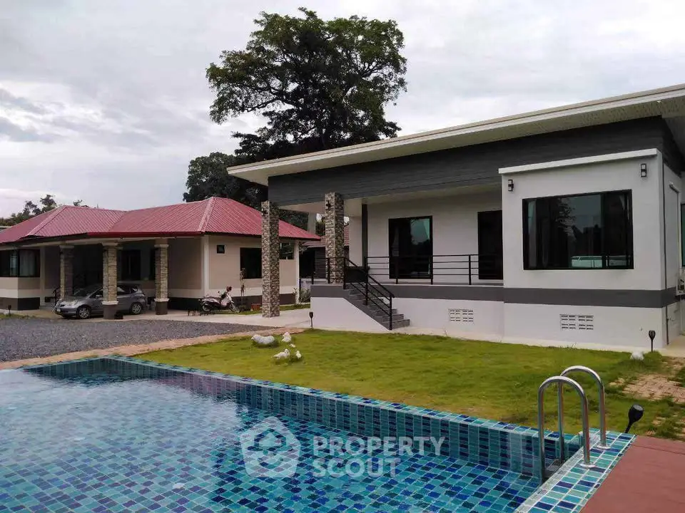 Modern single-story home with pool and lush garden, perfect for family living.