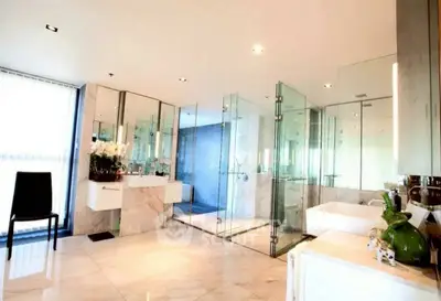 Luxurious modern bathroom with glass shower and marble flooring