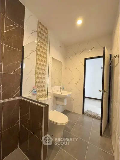 Modern bathroom with elegant tile design and spacious layout