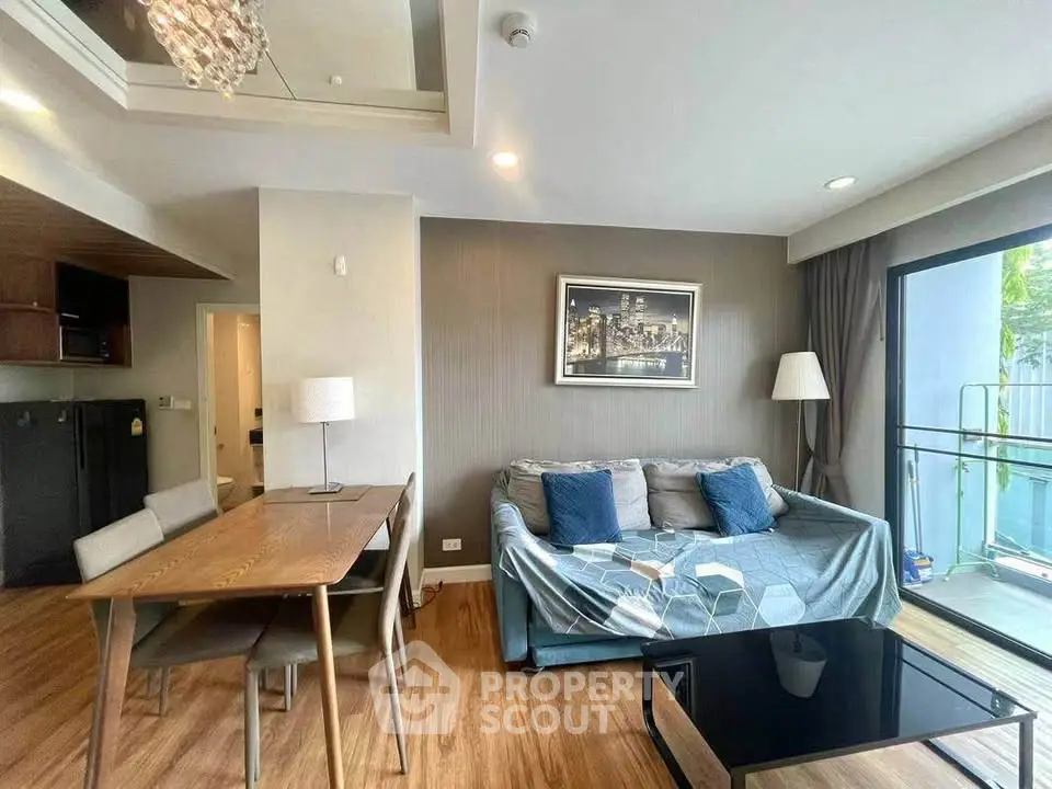 Modern living room with stylish decor and balcony access in a contemporary apartment.