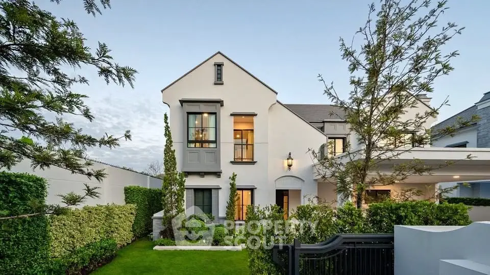 Elegant two-story home with manicured garden and modern architecture